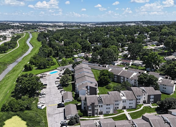 A suburban neighborhood with houses and a winding road.