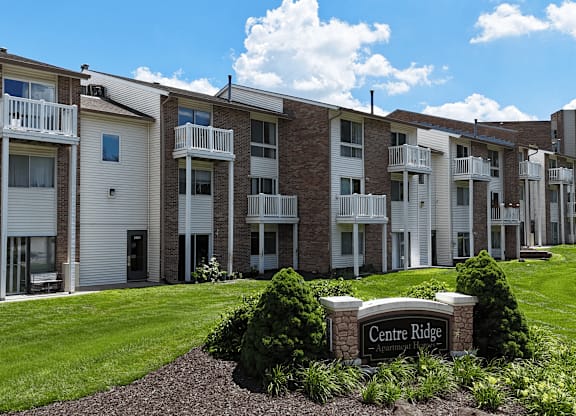 Apartment complex named Centre Ridge with a sign in front.