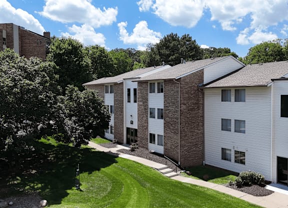 Apartment complex with a green lawn in front.