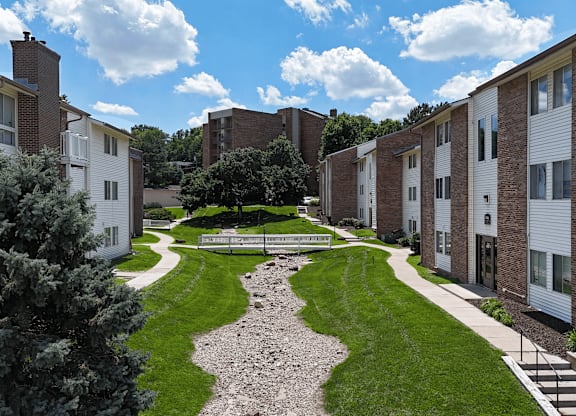 A residential area with a gravel pathway and grassy area.