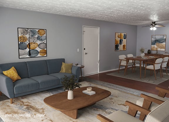 A living room with a blue couch and a coffee table.