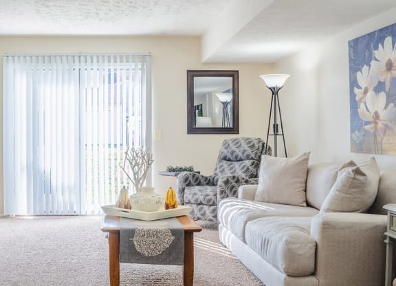 apartment living room with sliding glass door to patio