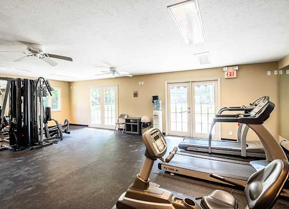 Apartment fitness center with treadmills, weights, and exercise equipment