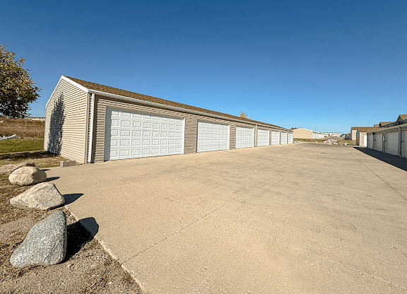 A long building with a garage door is in the foreground.