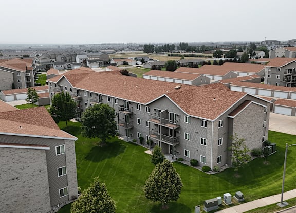 Apartment complex with a green lawn in front.