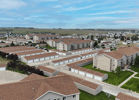 A large building complex with multiple buildings and a parking lot.