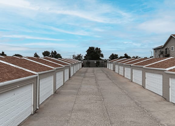 A long row of white garage doors are closed.