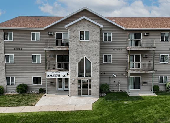 A large apartment building with a leasing office in the front.