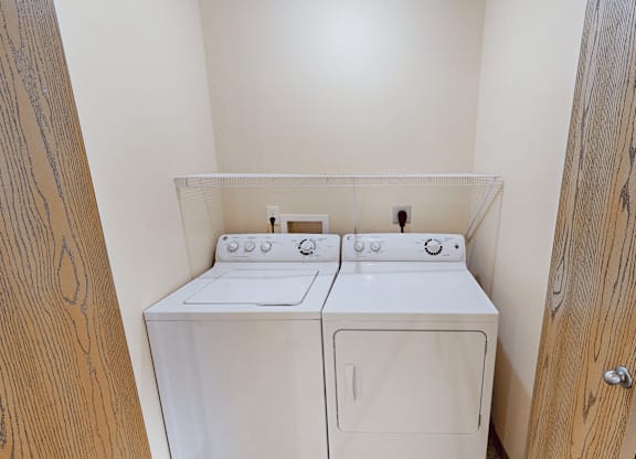 A small laundry room with a washer and dryer.