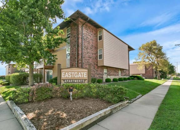 an image of the entrance to an apartment building with a sign that says eastgate apartments