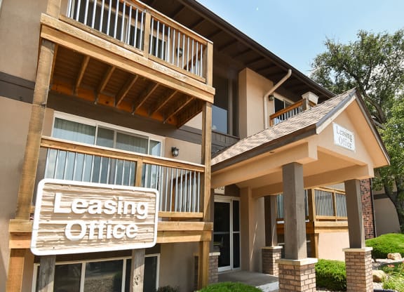 leasing office sign in front of an apartment building