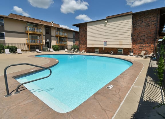 a swimming pool with a building in the background