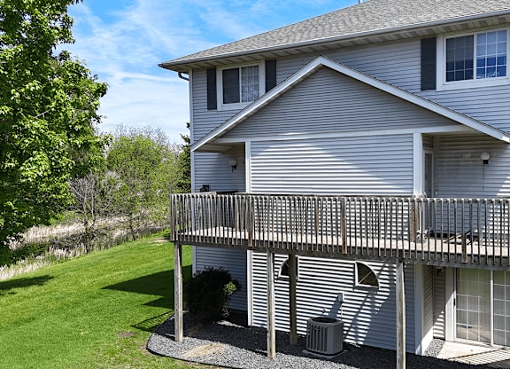 A house with a grey siding and a balcony.