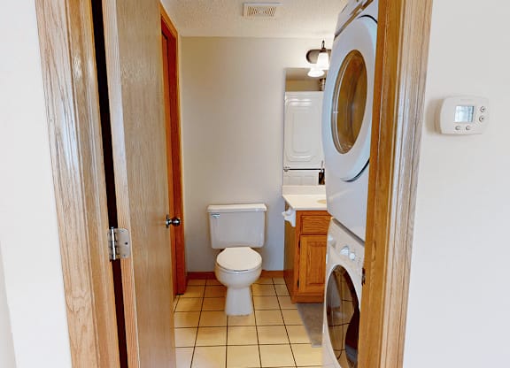 A small laundry room with a washer and dryer.
