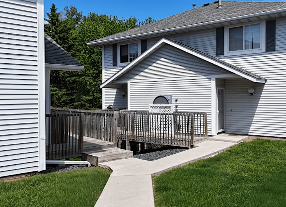 A house with a grey siding and a white window.