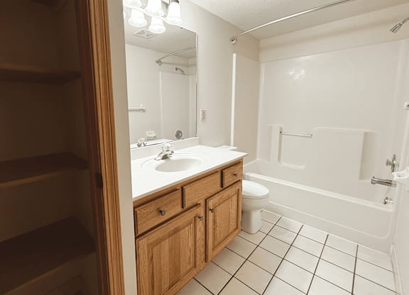 A bathroom with a white sink and a white toilet.