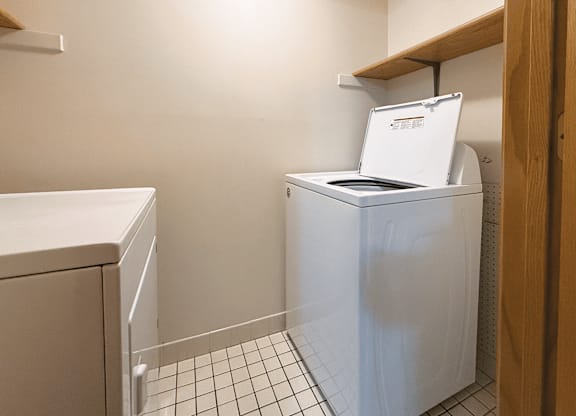 A white dishwasher is in a small kitchen.