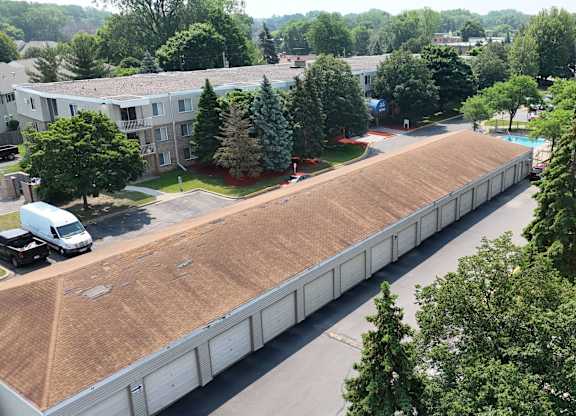 A parking lot is surrounded by apartment buildings.