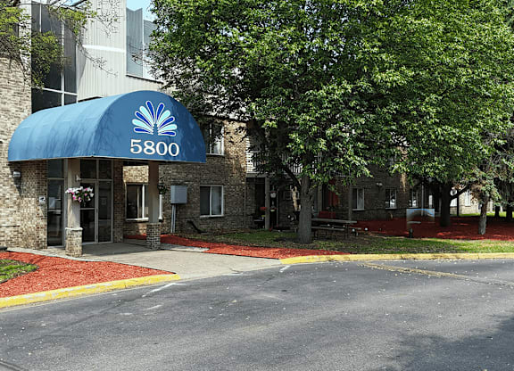 The front of a building with a blue awning that says 5800.