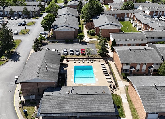 A swimming pool is surrounded by apartment buildings.