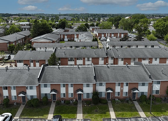 Apartment complex with a mix of red and white buildings.