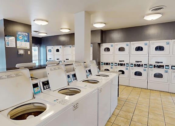 A row of washing machines in a public laundromat.