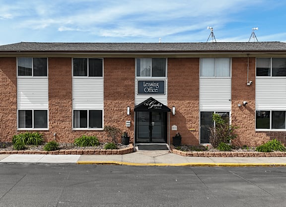 A brick building with a sign that says Leasing Office.