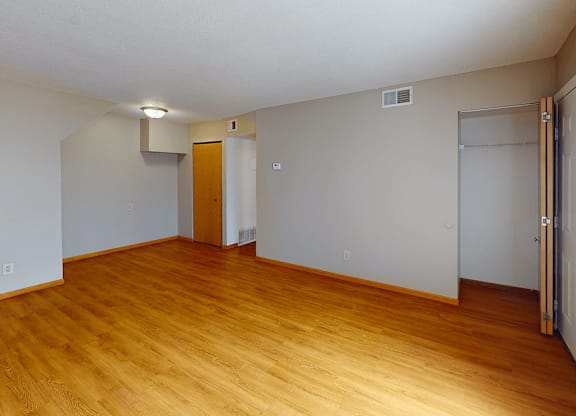 A room with wooden floors and a white ceiling.