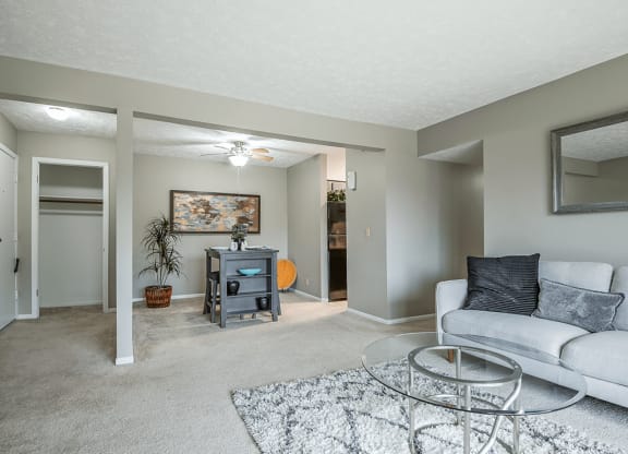 a living room with a couch and a glass coffee table