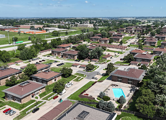 A large building complex with a swimming pool in the middle.