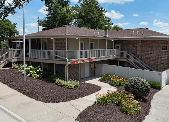 A brick building with a leasing sign on the door.
