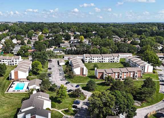 A bird's eye view of a residential area with houses and a swimming pool.