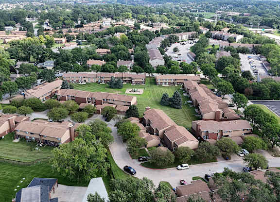 A large building complex with a green lawn in front.