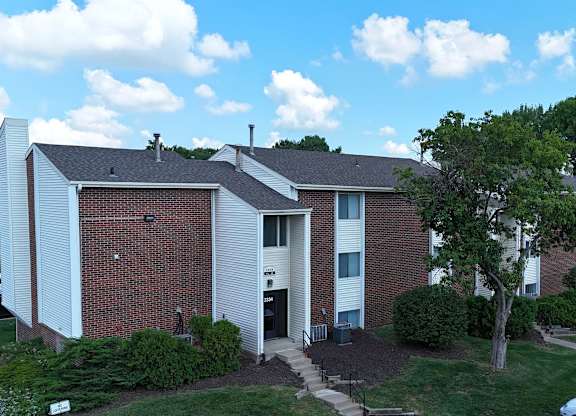 A brick house with a white door and a small porch.