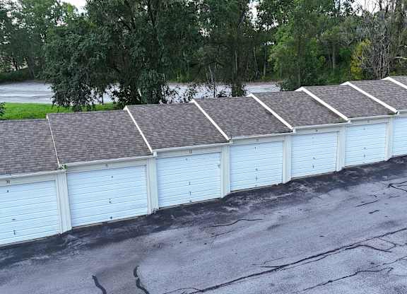 A row of white garage doors are closed.