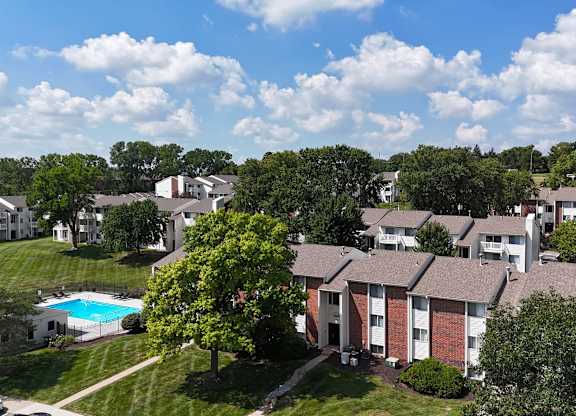 A view of apartment buildings with a pool in the foreground.