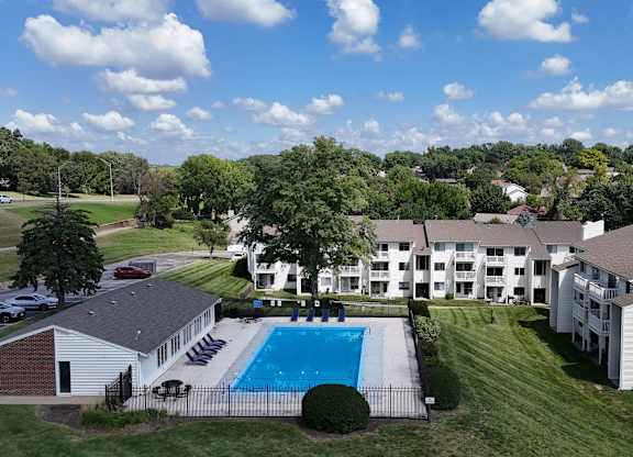 A large white building with a pool in front.