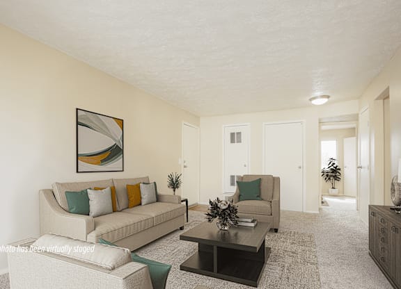 A living room with a couch, coffee table, and a painting on the wall.