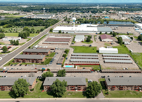 An aerial view of a large industrial area with multiple buildings and a parking lot.