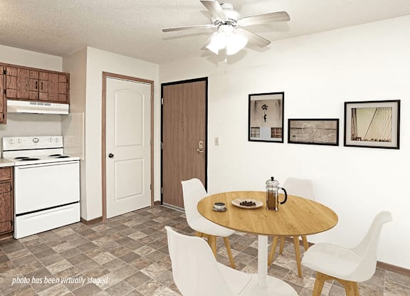 A kitchen with a table and chairs in the middle of the room.