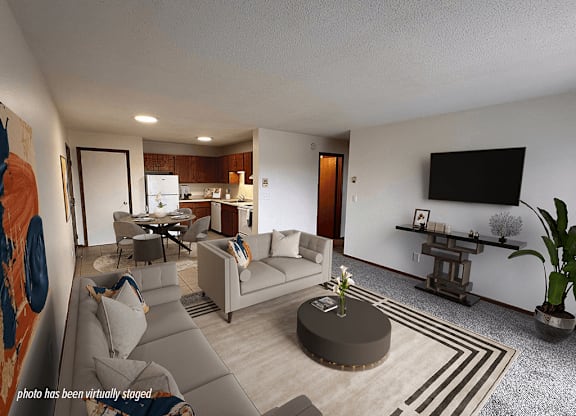 A living room with a grey couch and a coffee table.