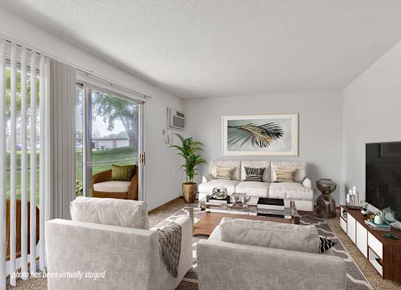 A living room with a couch, chair, and television.