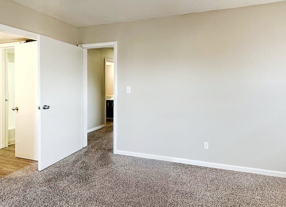 A room with a carpeted floor and white walls.