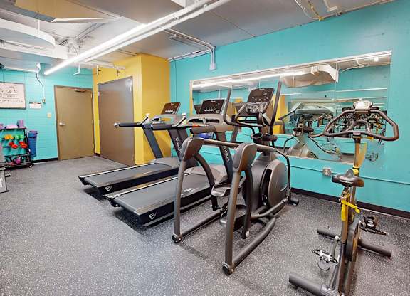 A gym with treadmills and exercise bikes.