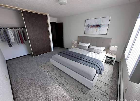 a bed room with a neatly made bed and a closet