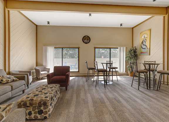 a resident clubhouse with couches chairs and tables