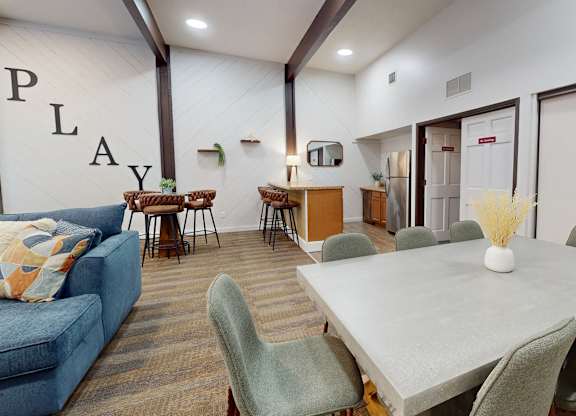 A community room with a large table and chairs.