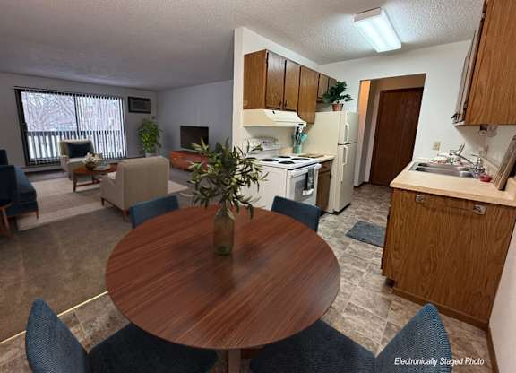 A dining room with a table and chairs.