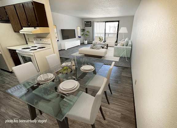 A virtual staged image of a modern dining room with a glass table and chairs.