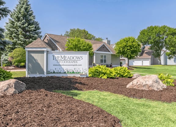 a home with a sign in front of it that says the meadows of commerce